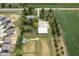 Aerial view of property with a large outbuilding, adjacent farmland, and neighborhood in the distance at 5538 N 700 W, McCordsville, IN 46055