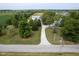 Aerial view of property with a long driveway, outbuilding, mature trees, and adjacent farmland at 5538 N 700 W, McCordsville, IN 46055