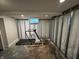 Unfinished basement gym area has a treadmill by the window at 5538 N 700 W, McCordsville, IN 46055