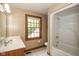 Bright bathroom features a shower and tub combination, with a large window for natural light at 5538 N 700 W, McCordsville, IN 46055