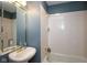 Bathroom features a vintage pedestal sink and a tub with white tiles and blue accent at 5538 N 700 W, McCordsville, IN 46055