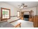 Well-lit bedroom provides ample space, light carpet, wood furniture and a ceiling fan at 5538 N 700 W, McCordsville, IN 46055
