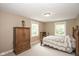 Comfortable bedroom with neutral walls, large windows and a bed with a white and gray patterned comforter at 5538 N 700 W, McCordsville, IN 46055