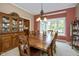 Elegant dining room with a large wooden table, china cabinet, and bay window, ideal for Gathering gatherings at 5538 N 700 W, McCordsville, IN 46055