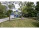 View of the side of a blue home with a three-car garage and mature trees in a beautiful landscaped yard at 5538 N 700 W, McCordsville, IN 46055