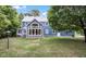 Back exterior featuring a large, two-story blue home with a large lawn and large doors letting in ample light at 5538 N 700 W, McCordsville, IN 46055