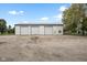 Large metal outbuilding featuring 3 garage doors and a side door, providing ample storage for vehicles and equipment at 5538 N 700 W, McCordsville, IN 46055