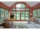 Bright living room with vaulted ceiling, large windows, and comfortable seating area at 5538 N 700 W, McCordsville, IN 46055