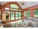 Bright living room with vaulted ceiling, large windows, and comfortable seating area at 5538 N 700 W, McCordsville, IN 46055