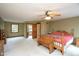 Spacious main bedroom with ensuite bathroom, ceiling fan, and bench at the foot of the bed at 5538 N 700 W, McCordsville, IN 46055