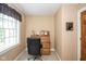 Compact office space with natural light, a wooden rolltop desk, and a comfortable black office chair at 5538 N 700 W, McCordsville, IN 46055
