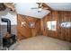 Unique room featuring wood paneled walls, a wood-burning fireplace, and a moose head, creating a cozy and rustic atmosphere at 5538 N 700 W, McCordsville, IN 46055
