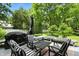 Cozy deck with outdoor seating, including chairs and a bench, ideal for enjoying the serene backyard at 5922 Broadway St, Indianapolis, IN 46220