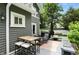 Well-maintained deck with dining table, chairs, and a built-in bench, creating a comfortable outdoor space at 5922 Broadway St, Indianapolis, IN 46220