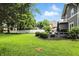 Expansive backyard with a well-maintained lawn, deck, and lush greenery, offering ample space for recreation at 5922 Broadway St, Indianapolis, IN 46220