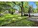 Expansive backyard with basketball hoop, garage, white fence, and lush greenery at 5922 Broadway St, Indianapolis, IN 46220