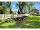 Brick patio featuring a picnic table in a landscaped backyard with a white fence at 5922 Broadway St, Indianapolis, IN 46220