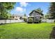 Beautiful backyard featuring mature trees and lush green lawn, offering a private oasis for relaxation and play at 5922 Broadway St, Indianapolis, IN 46220