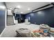 Finished basement offering a study area, comfortable seating and carpeted stairs at 5922 Broadway St, Indianapolis, IN 46220