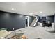 Finished basement featuring neutral carpet, a desk, and a comfortable seating area at 5922 Broadway St, Indianapolis, IN 46220