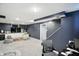 Finished basement area featuring comfortable seating, desk, and carpeted floors at 5922 Broadway St, Indianapolis, IN 46220