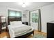 Cozy bedroom with hardwood floors and ample natural light at 5922 Broadway St, Indianapolis, IN 46220