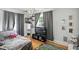 Bedroom with a large window, hardwood floors, and themed decor at 5922 Broadway St, Indianapolis, IN 46220
