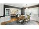 Warm dining room with a wooden table and view to the living area through French doors at 5922 Broadway St, Indianapolis, IN 46220