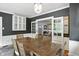 Lovely dining space with neutral decor, a rustic table, and French doors at 5922 Broadway St, Indianapolis, IN 46220