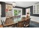 Charming dining area with a rustic wood table and view to the backyard through glass doors at 5922 Broadway St, Indianapolis, IN 46220