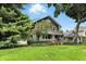 Beautiful home showcasing its lush front lawn, vibrant flowerbeds, and mature trees at 5922 Broadway St, Indianapolis, IN 46220