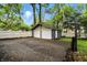Two-car garage with a basketball hoop located on a paved driveway and surrounded by greenery at 5922 Broadway St, Indianapolis, IN 46220