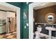 Hallway leads to a kitchen with stainless steel appliances and a powder room at 5922 Broadway St, Indianapolis, IN 46220