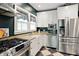 Modern kitchen with stainless steel appliances, granite counters, and a large sink at 5922 Broadway St, Indianapolis, IN 46220