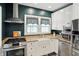 Bright kitchen featuring stainless steel appliances, a farm sink, and granite countertops at 5922 Broadway St, Indianapolis, IN 46220