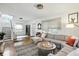 Well-lit living room with hardwood floors, a large sectional sofa, and a cozy atmosphere at 5922 Broadway St, Indianapolis, IN 46220