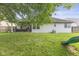 Grassy backyard showcasing a patio with outdoor furniture, well-maintained lawn, and play area at 5986 Regency Dr, Columbus, IN 47203