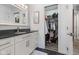 Bathroom featuring granite countertop, white cabinets, tile flooring, and a walk in closet at 5986 Regency Dr, Columbus, IN 47203