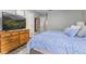 A cozy bedroom features blue bedding, a wooden dresser, and neutral colored walls at 5986 Regency Dr, Columbus, IN 47203