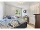 Cozy bedroom with a patterned bedspread, soft lighting, and a serene atmosphere at 5986 Regency Dr, Columbus, IN 47203