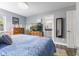 Comfortable bedroom with blue bedding, wooden dresser, TV, and ensuite bathroom access at 5986 Regency Dr, Columbus, IN 47203
