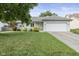 Charming single-story home featuring a well-manicured lawn and an attached two-car garage at 5986 Regency Dr, Columbus, IN 47203