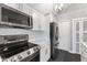 Well-appointed kitchen with stainless steel appliances, white cabinets, and subway tile backsplash at 5986 Regency Dr, Columbus, IN 47203