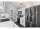 Stylish kitchen featuring white cabinets, marble countertops, and black stainless steel appliances at 5986 Regency Dr, Columbus, IN 47203