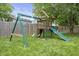 Backyard playground with swings, a slide, and a fort for outdoor fun and recreation at 5986 Regency Dr, Columbus, IN 47203
