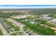 An aerial view of a neighborhood showcasing homes, streets, and landscaping with a commercial area in the background at 6536 Apperson Dr, Noblesville, IN 46060