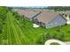 Aerial view of the backyard highlighting its lush lawn and covered patio, with a perspective of the surrounding community at 6536 Apperson Dr, Noblesville, IN 46060