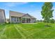 Grassy backyard featuring a covered porch, perfect for entertaining and relaxing at 6536 Apperson Dr, Noblesville, IN 46060