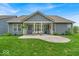 Charming home backyard featuring a covered patio, swing, grill and lush green lawn at 6536 Apperson Dr, Noblesville, IN 46060