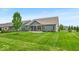 Well-maintained lawn featuring covered back porch and fresh landscaping at 6536 Apperson Dr, Noblesville, IN 46060